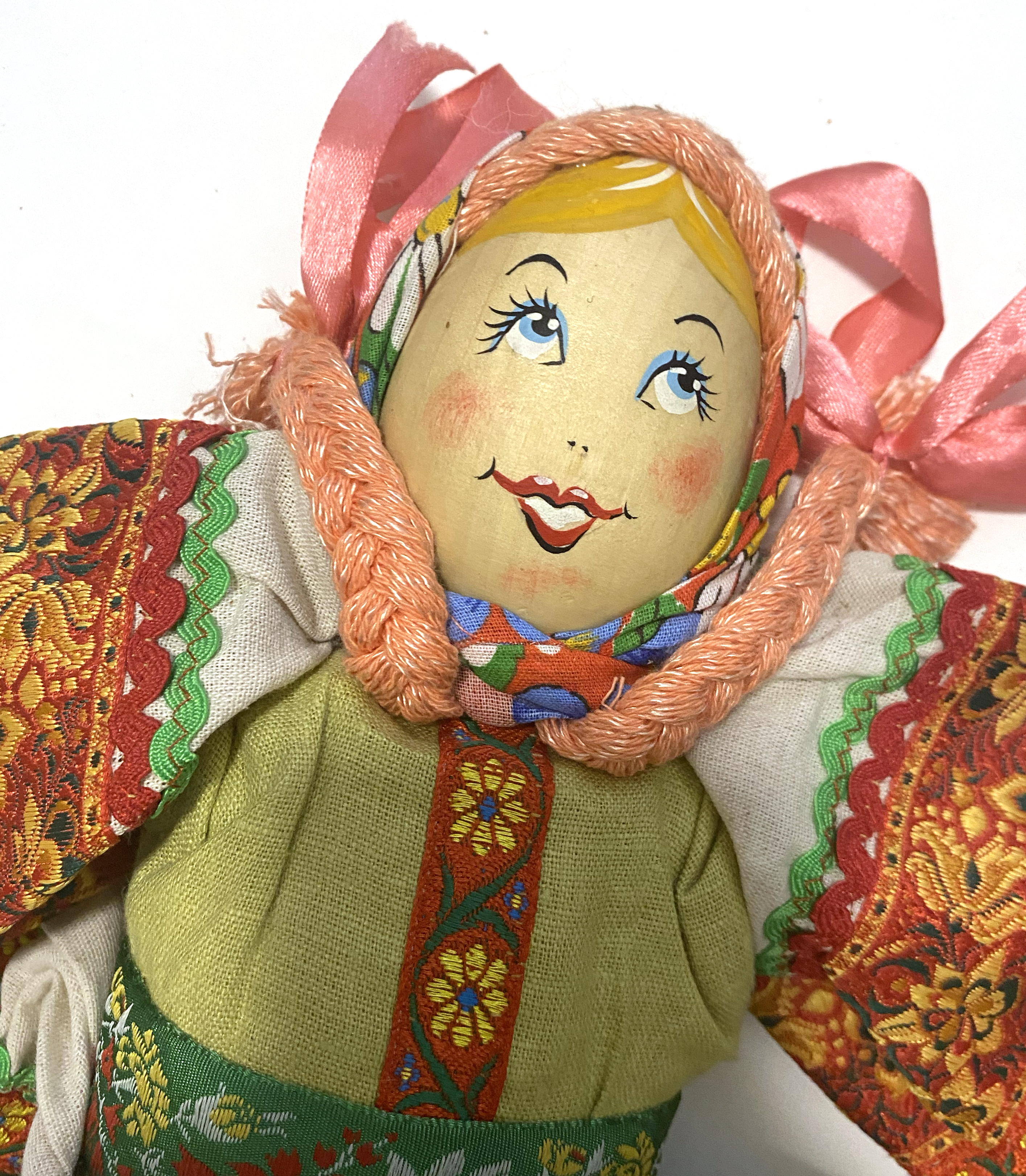 Cloth doll with wooden face, pink braided girl