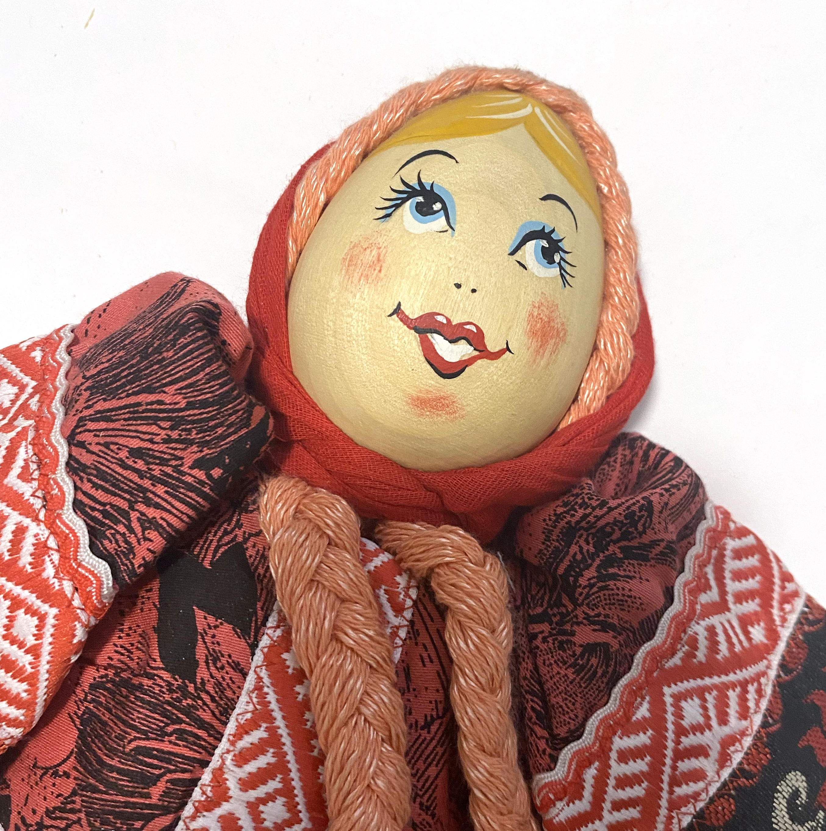 Cloth doll with wooden face, red black girl